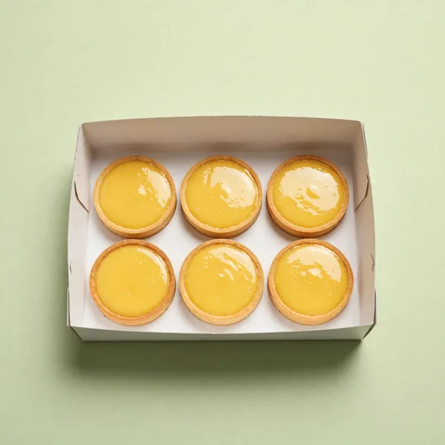 Six lemon tarts in a plain box
