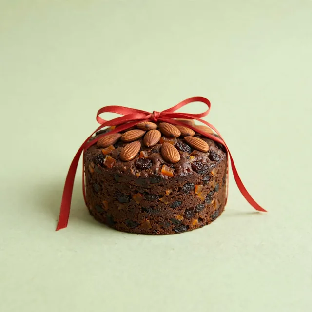 A small fruit cake with a ribbon